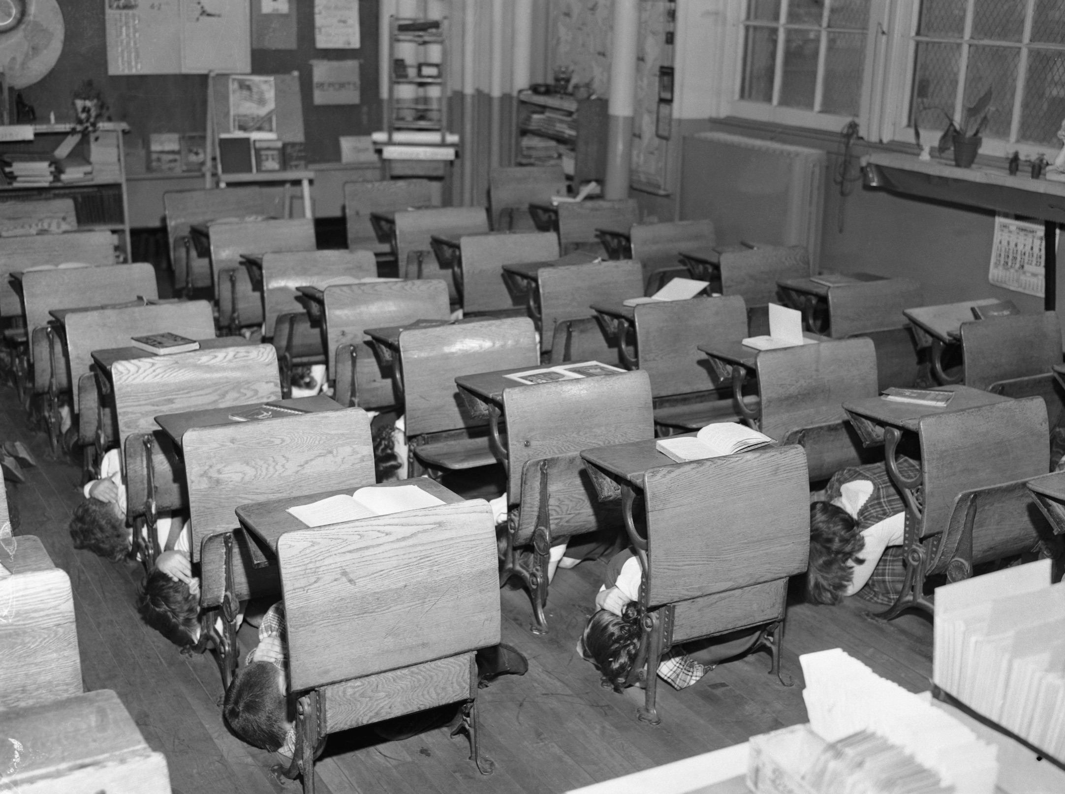School children practicing the Duck and Cover drill, to protect themselves against the effects of a nuclear explosion